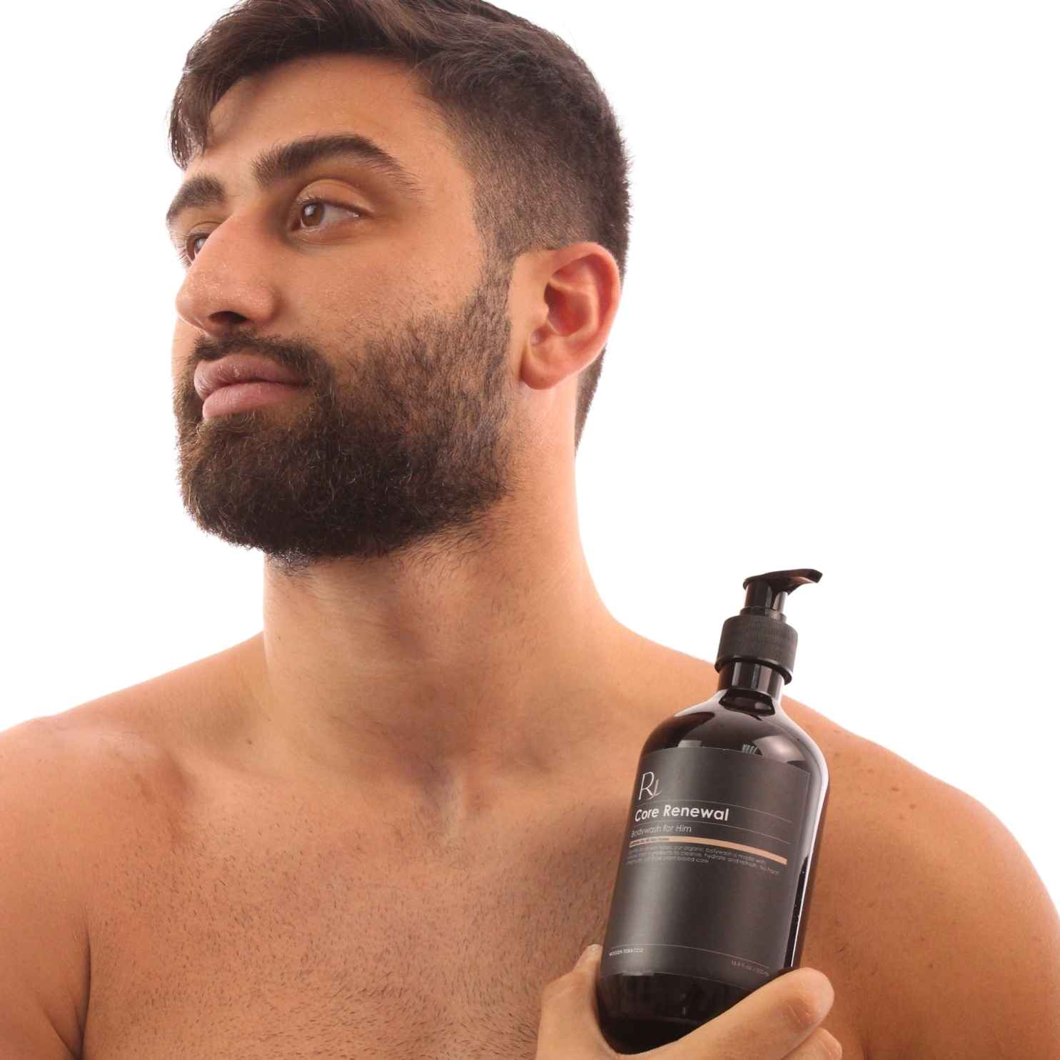 Model holding Raqiia Core Renewal Bodywash in front of white background