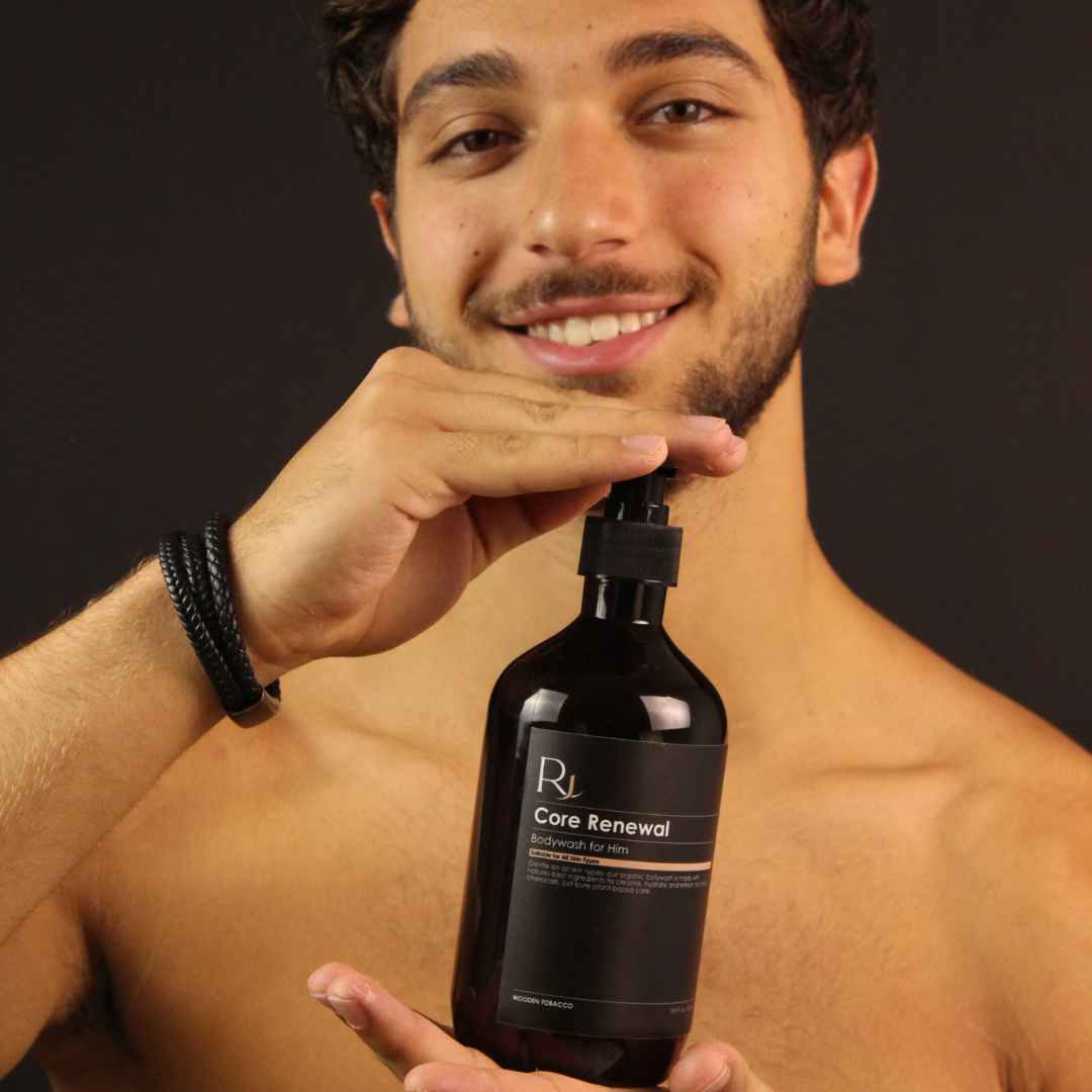 Model holding Raqiia Core Renewal Bodywash in front of black background