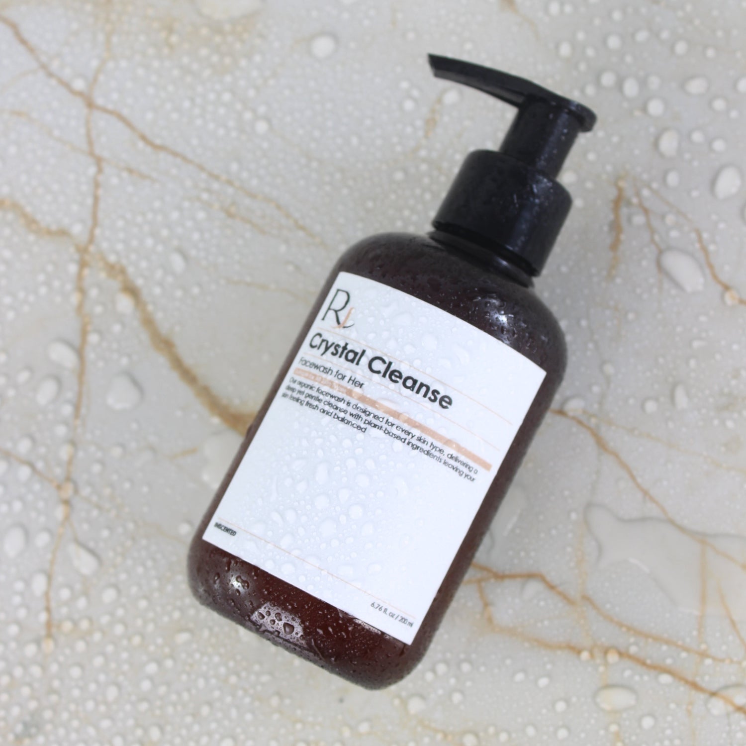 Bottle of Raqiia Crystal Cleanse Facewash on a marble surface