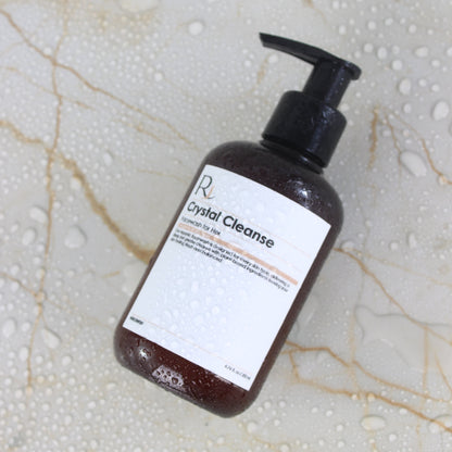 Bottle of Raqiia Crystal Cleanse Facewash on a marble surface