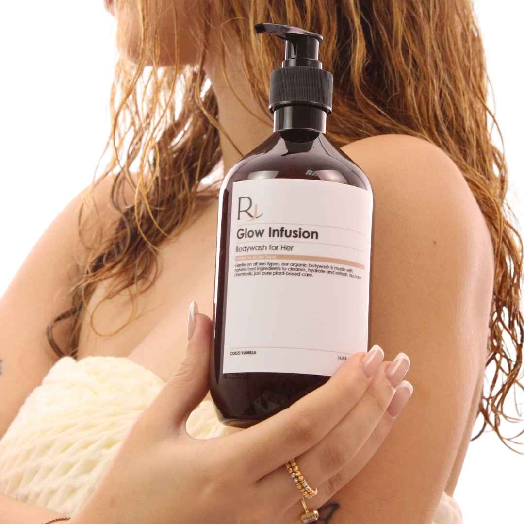 Bottle of 'Raqiia Glow Infusion' body wash held by a person with a blurred background