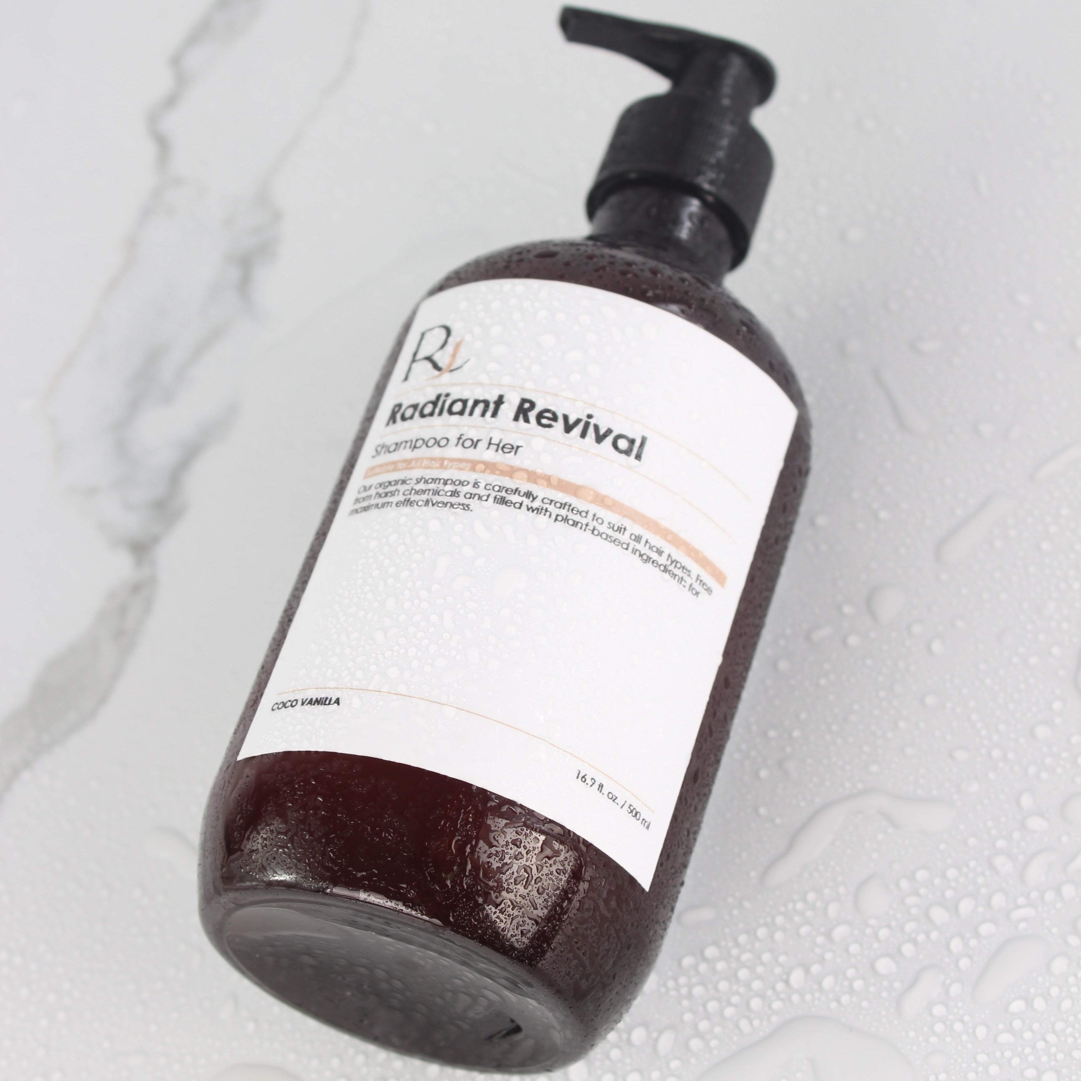 Raqiia Radiant Revival Shampoo with condensation on white marbel