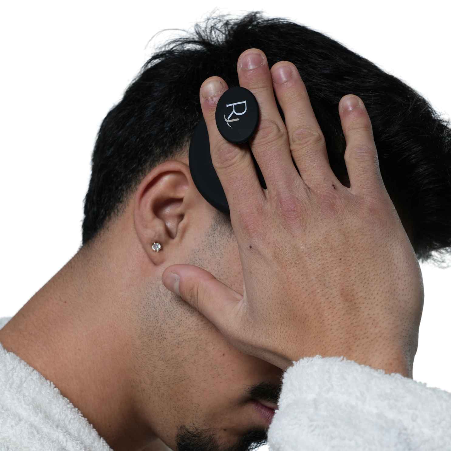 Male Model using Black Raqiia Scalp Massager in front of white background