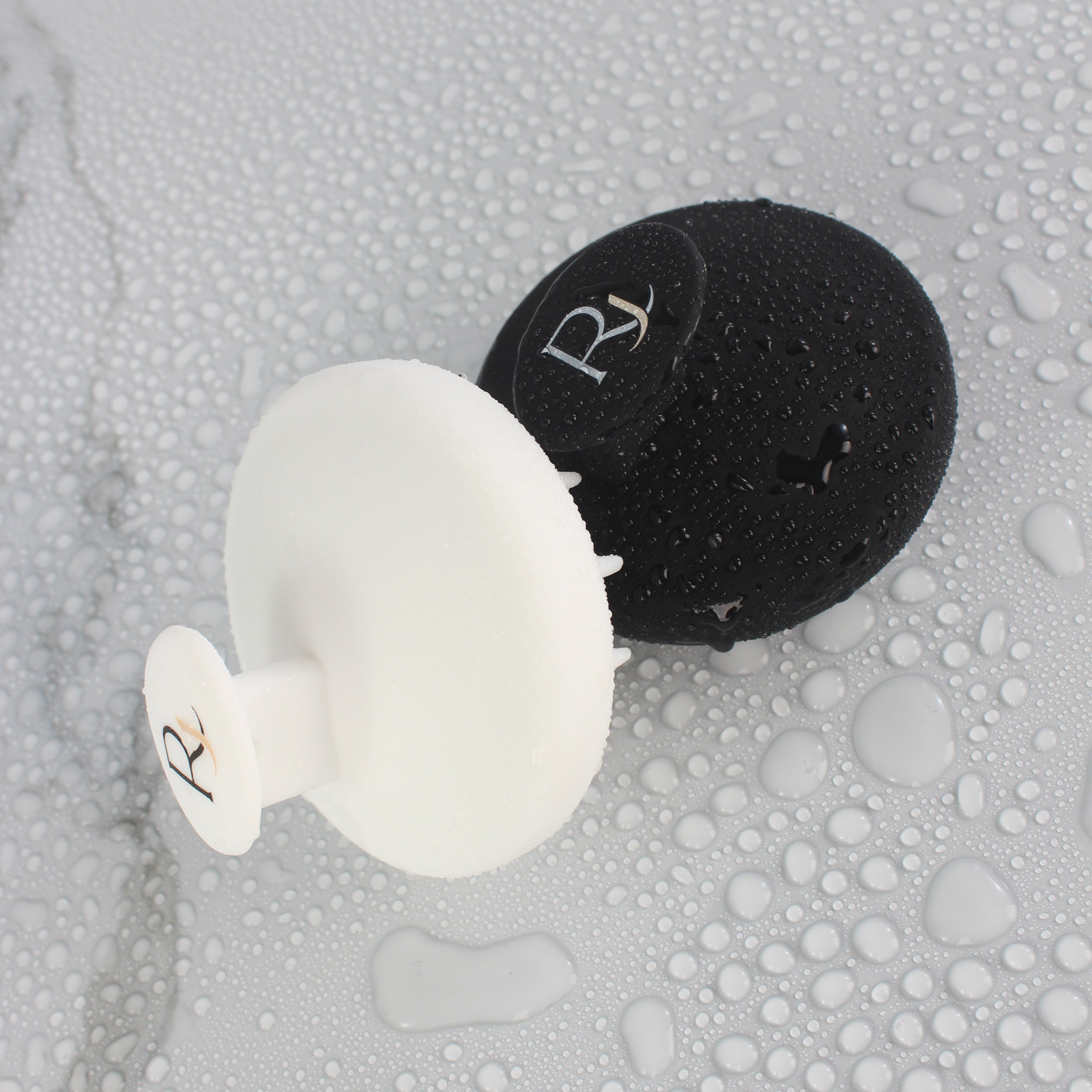 White and Black Raqiia Scalp Massagers on white marble