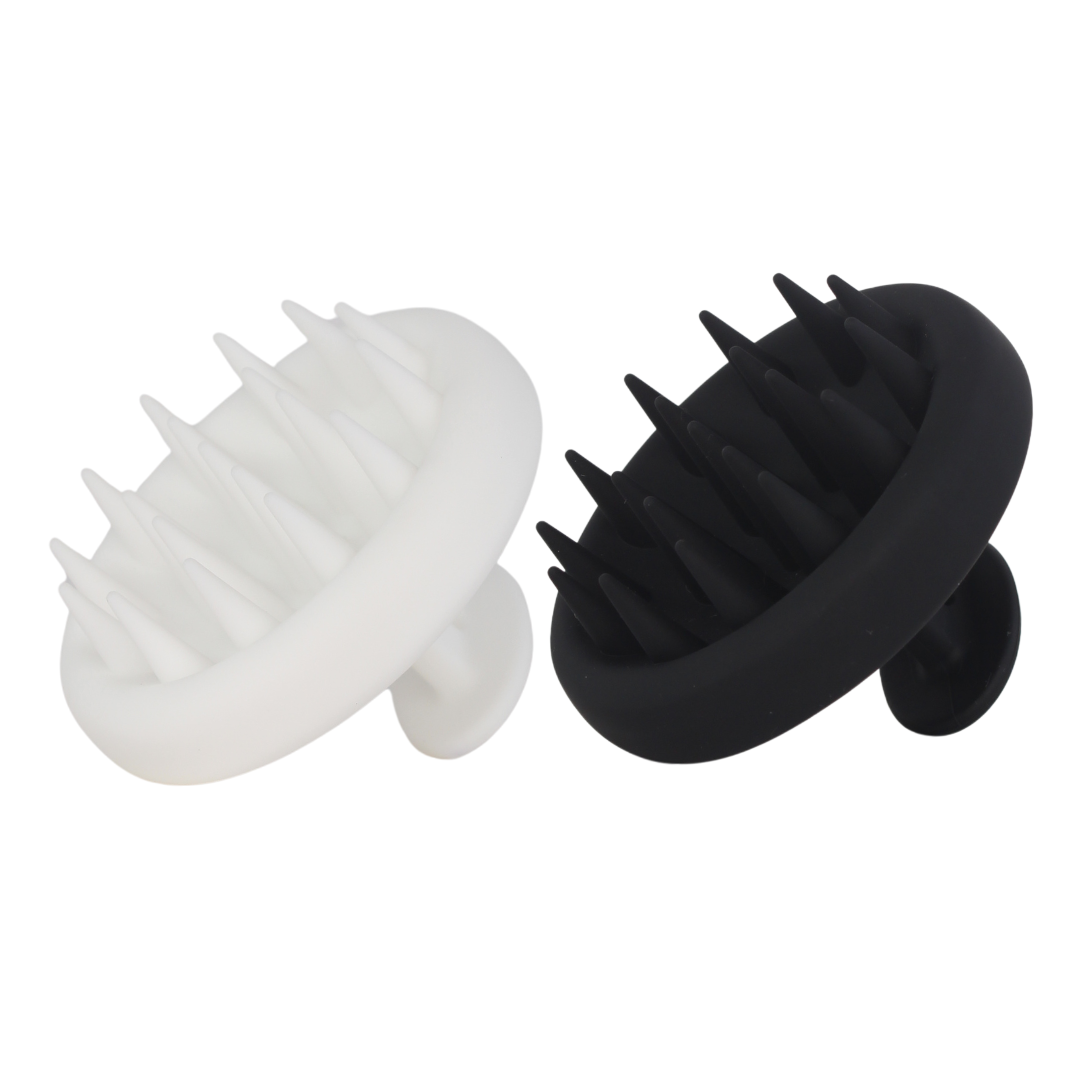 White and black Raqiia scalp massager on a white background